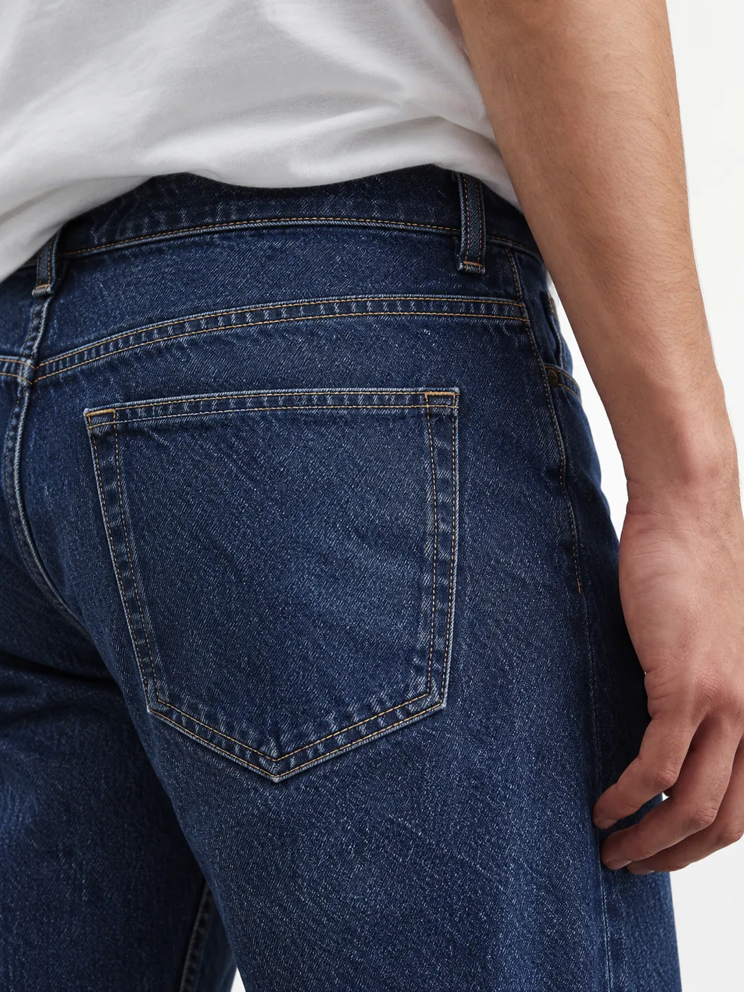 Back pocket of dark jeans being worn