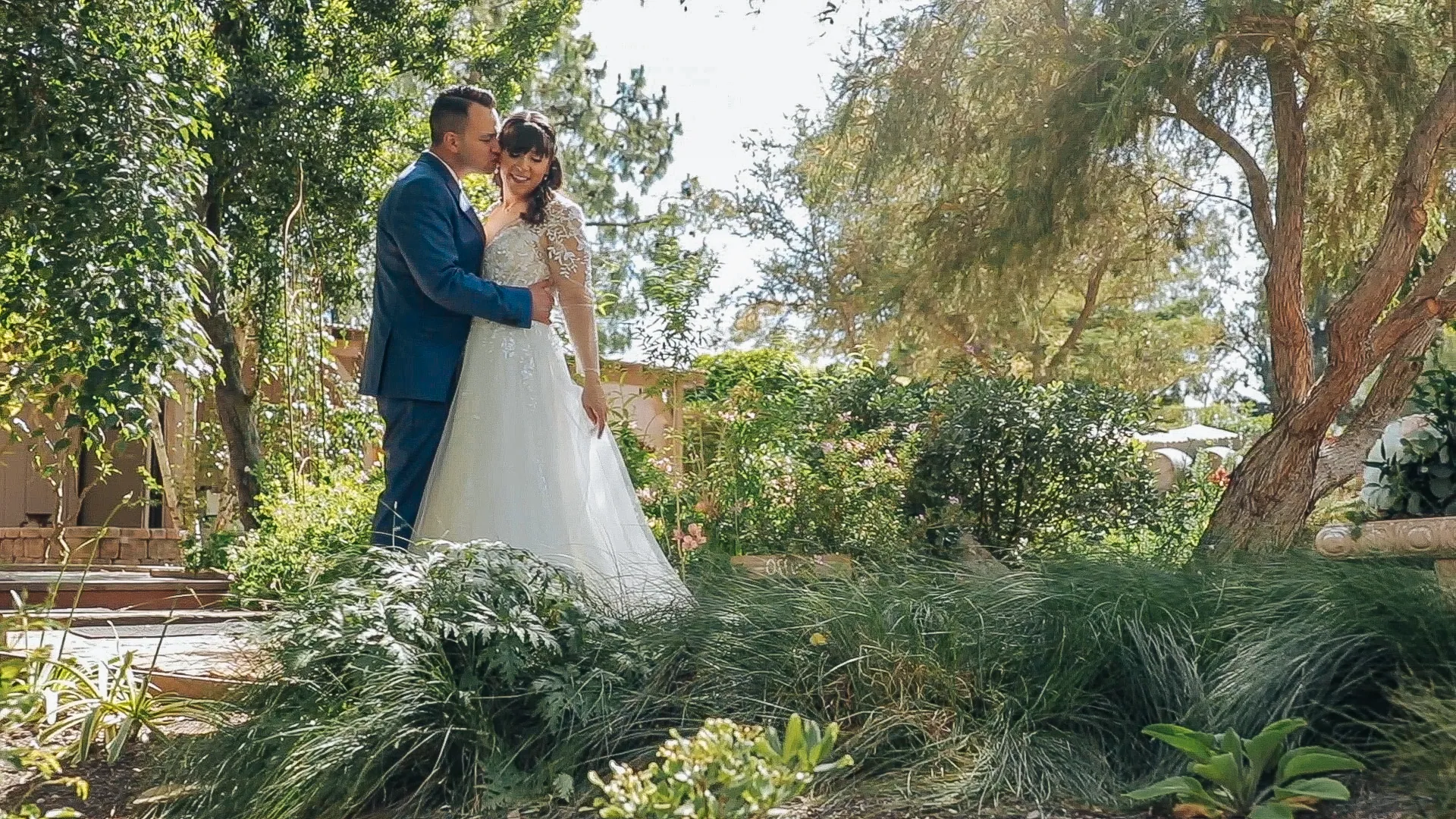 Joyful newlyweds raise their hands as guests cheer after the ceremony.