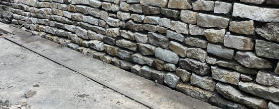 Natural stone dry-stacked retaining wall in a residential landscape