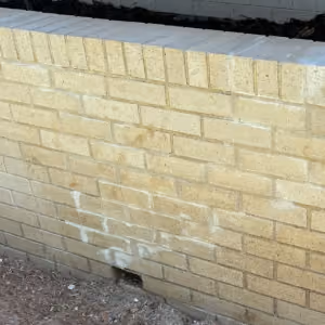 New PVC drain line with catch basins installed to carry water away from the wall