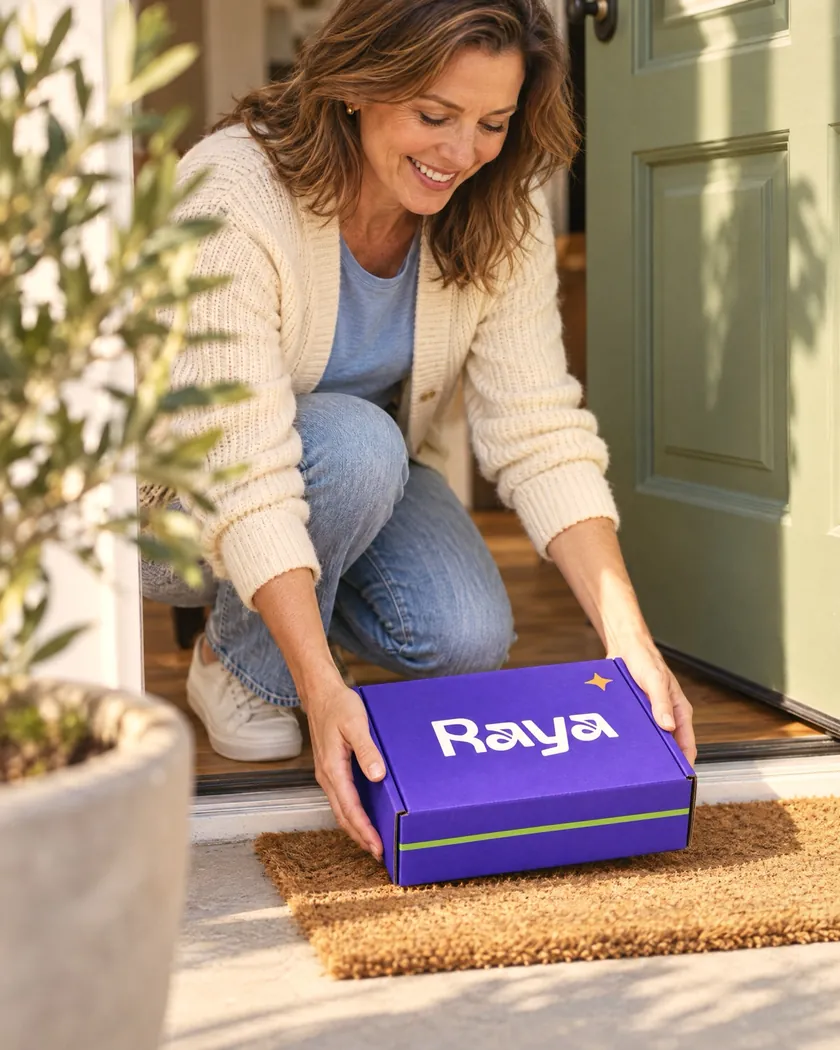 Woman opening a Raya delivery box at her front door