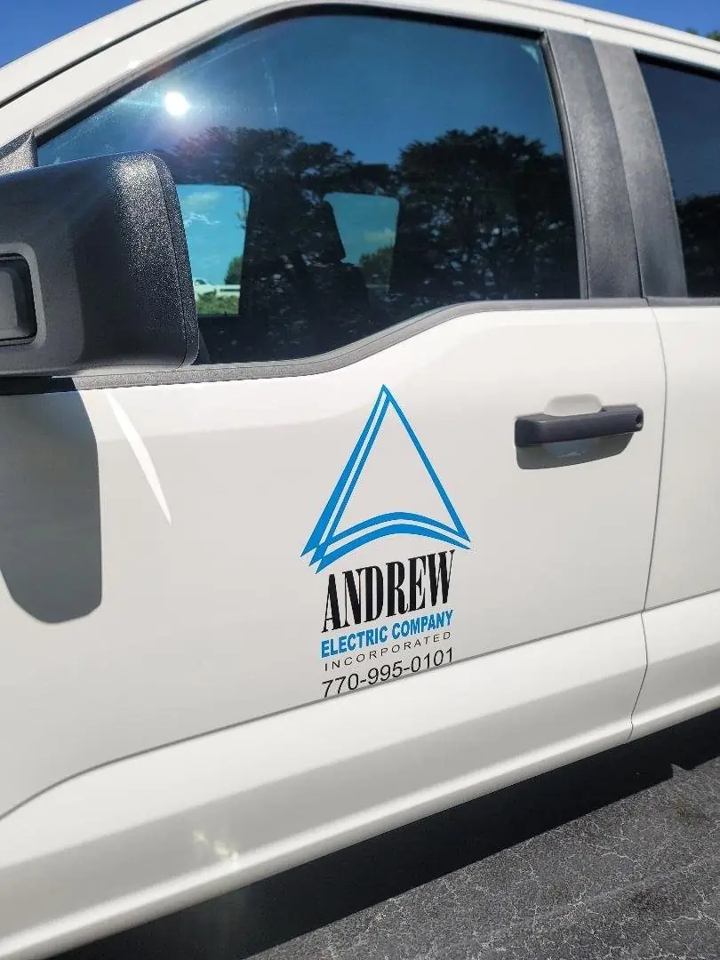 Vinyl logo and lettering on an Andrew Electric work truck door
