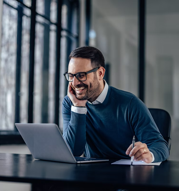 Smiling man on a video consultation call at his laptop