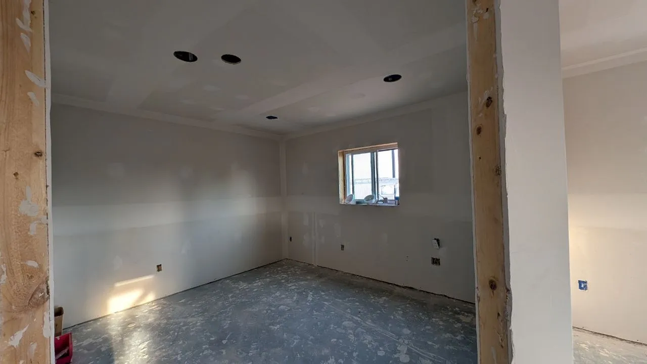 Taped drywall bedroom with recessed light cutouts