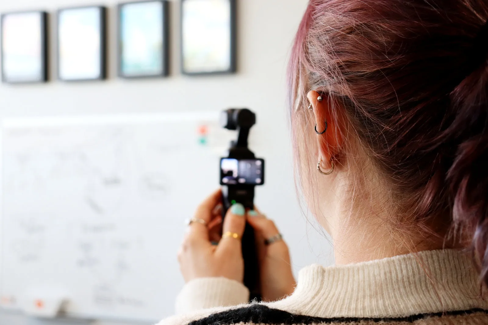 A Pollard Media team member filming in the office on a pocket gimbal camera