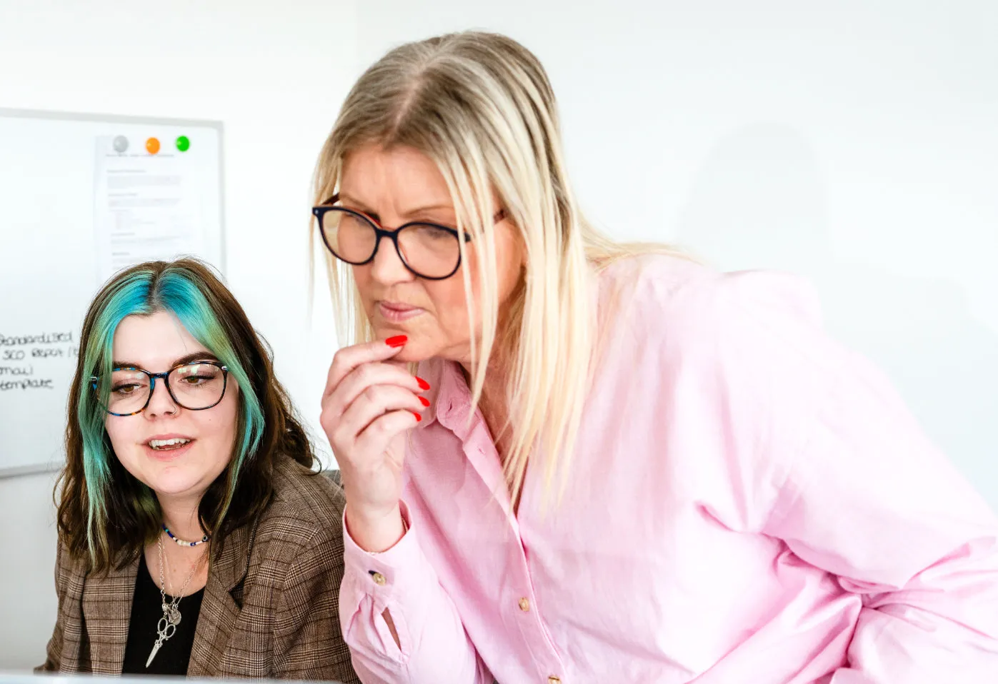 Pollard Media team members working at a desk analysing data