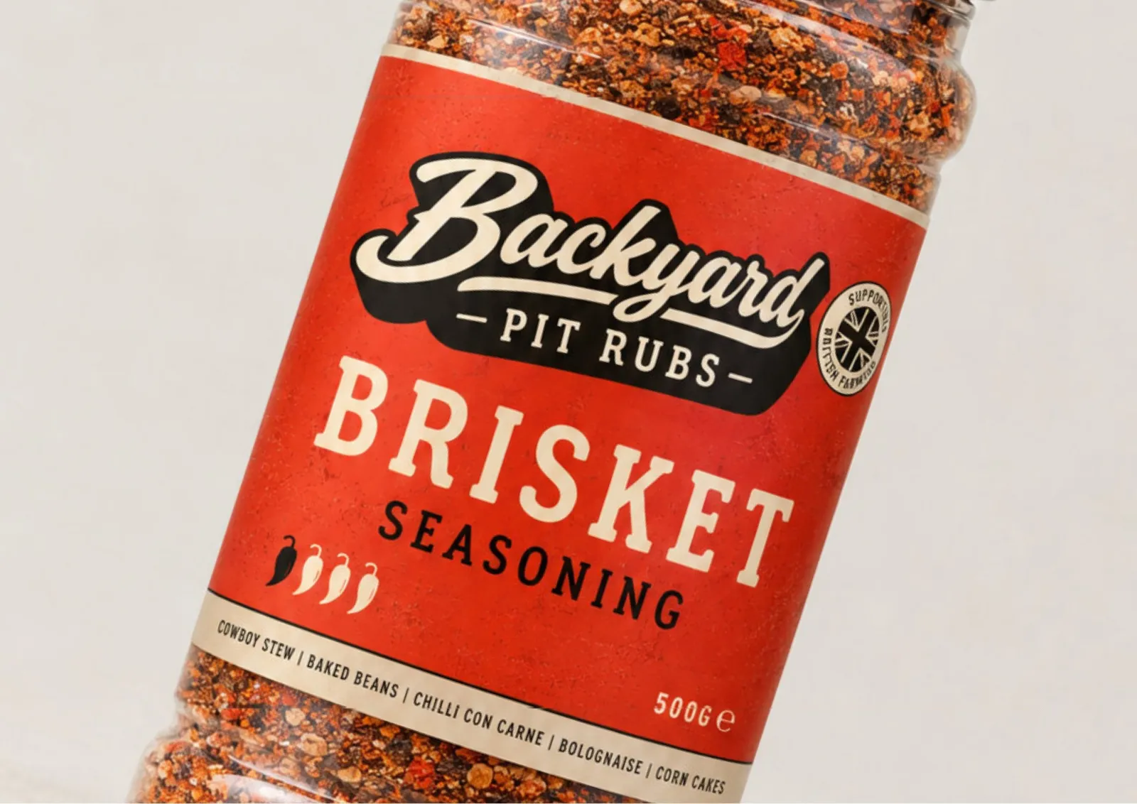 A jar of Backyard Pit Rubs Brisket Seasoning with the red label, the Backyard script logo and the Pit Rubs banner.
