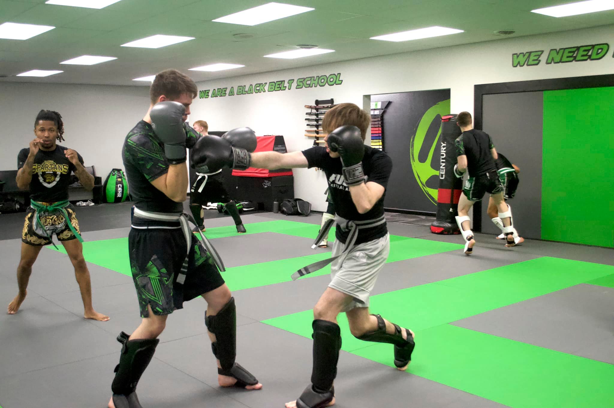 Adult Muay Thai glove and pad training at Fusion Martial Arts in Bloomington, IL