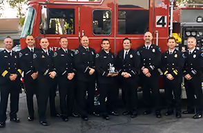 Santee Firefighters Association members in dress uniform in front of a fire engine