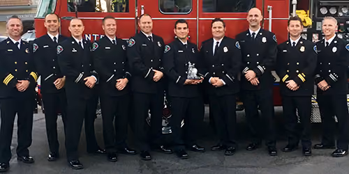 Santee Firefighters Association board members in dress uniform in front of a fire engine