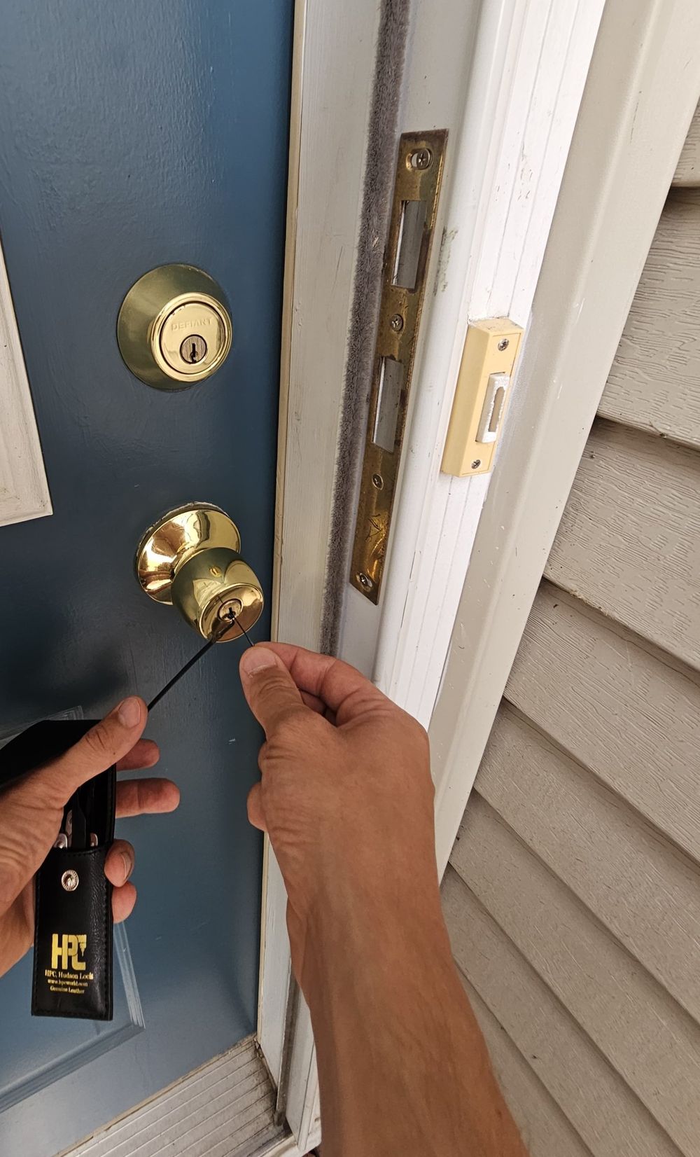 Titan Lock & Key locksmith unlocking a house door during a residential lockout