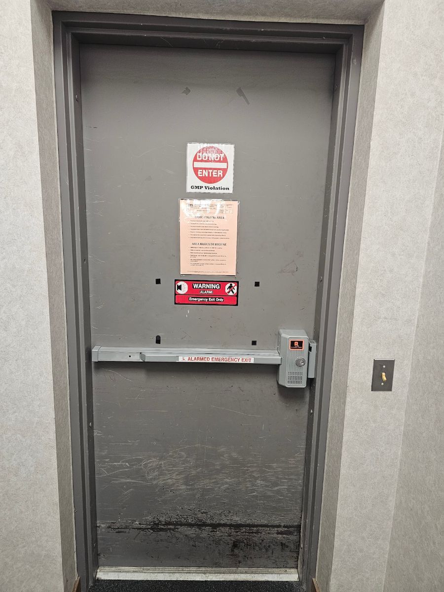 Alarmed panic exit device installed on a commercial door