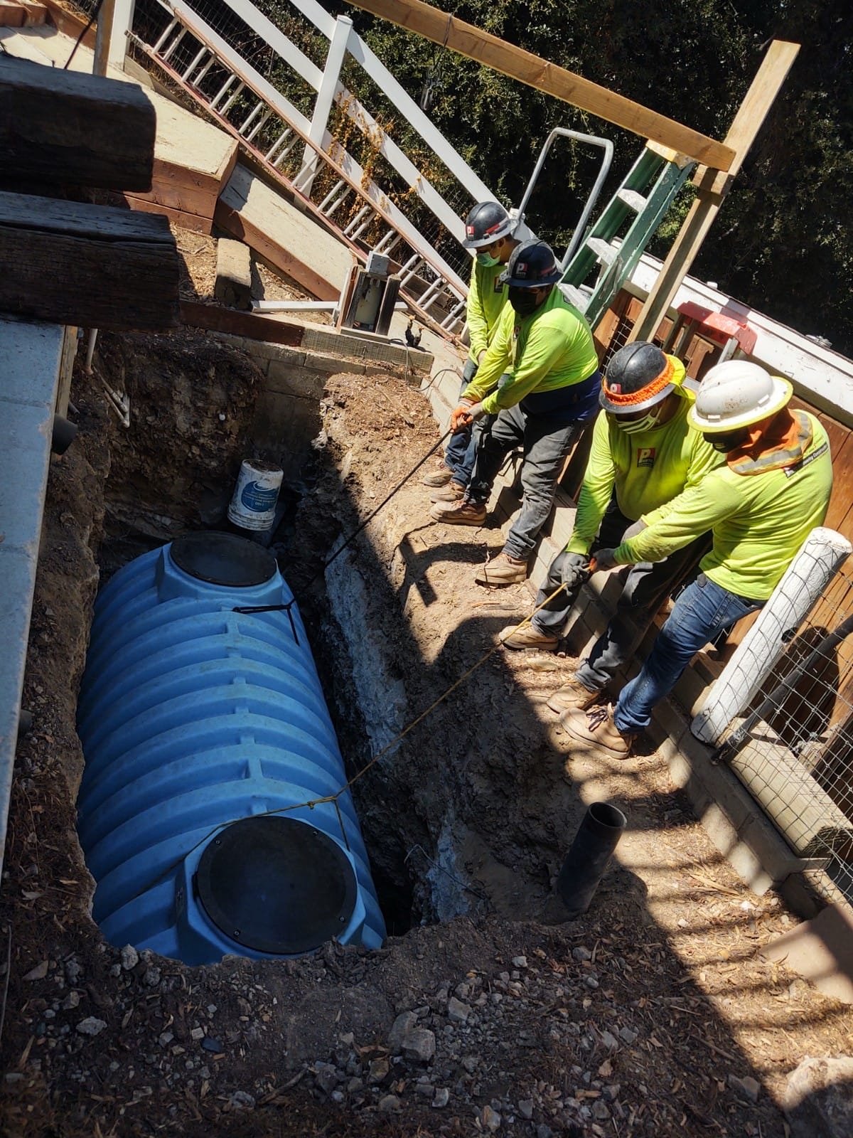 Crew installing a poly septic tank