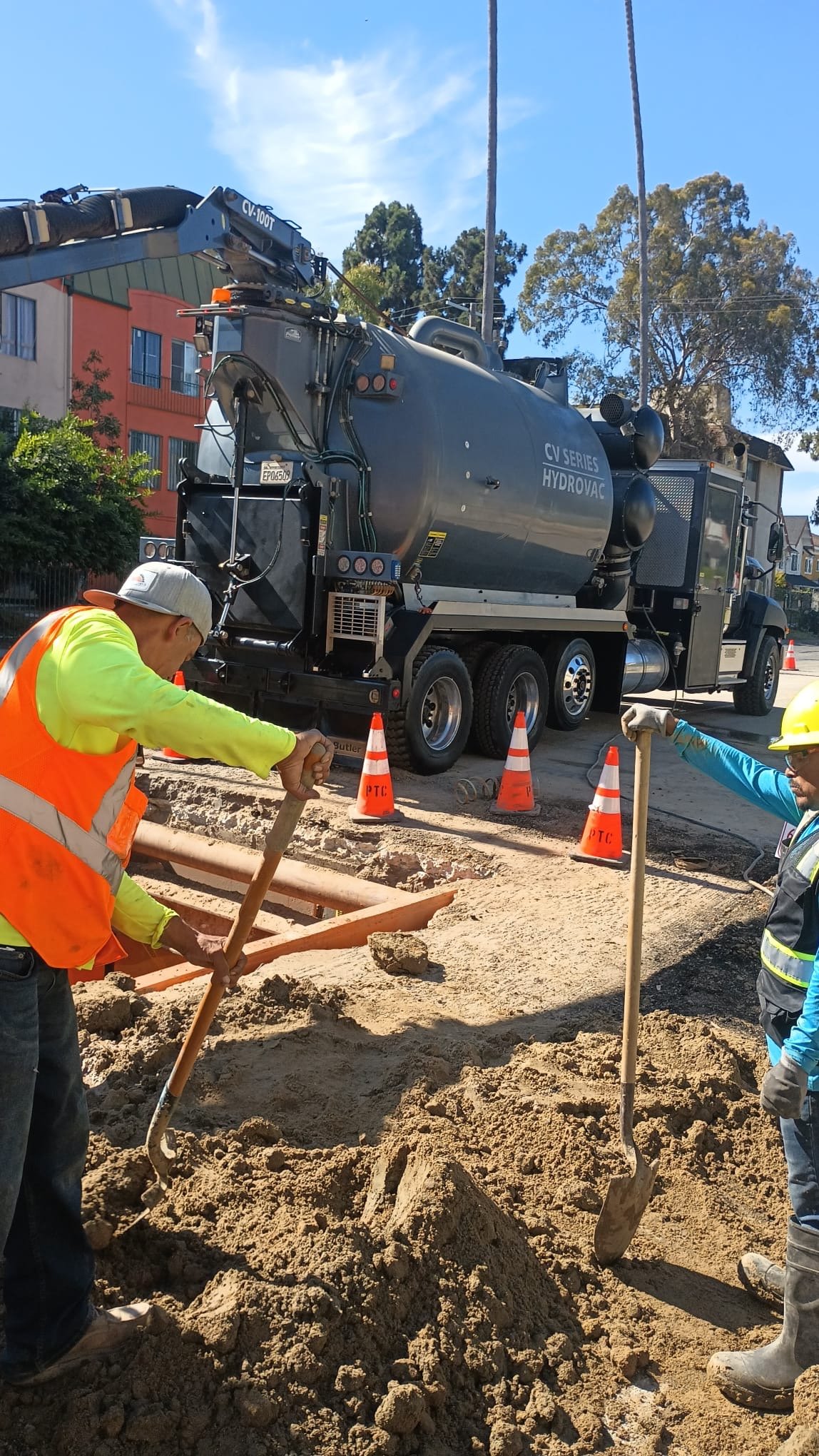 Crew working a utility trench with hydrovac