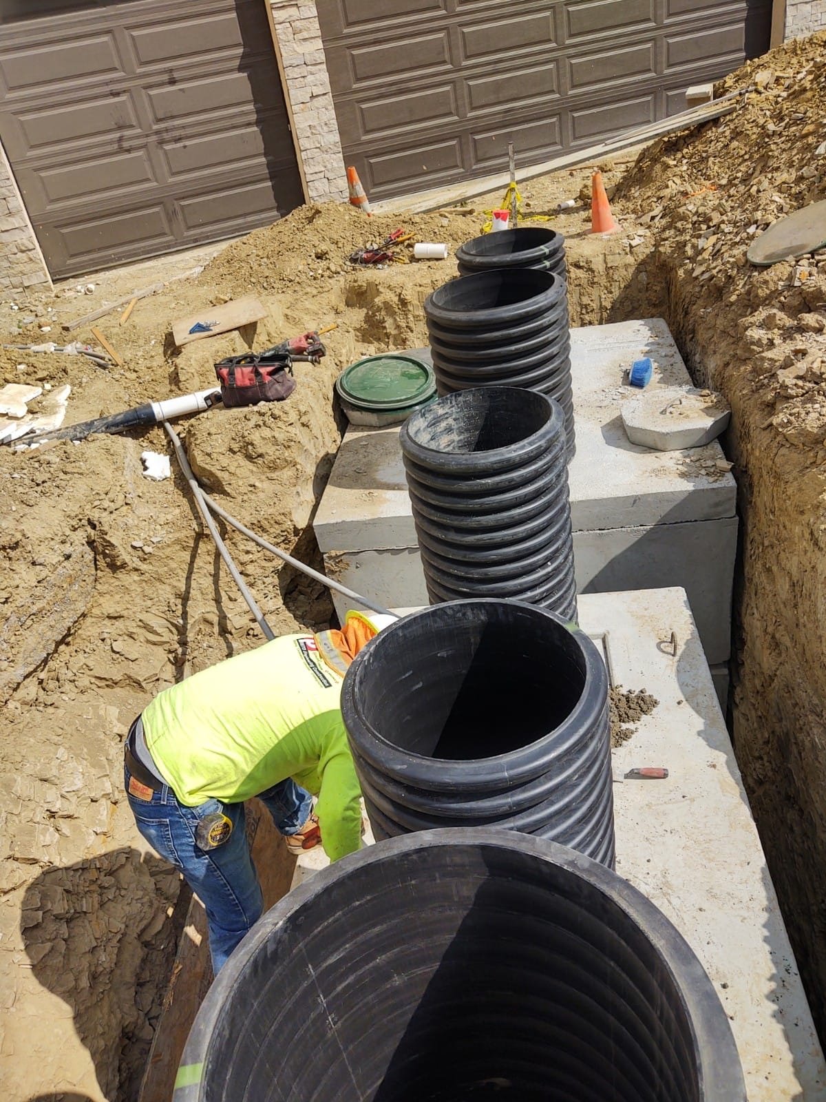 Septic tank and risers being installed