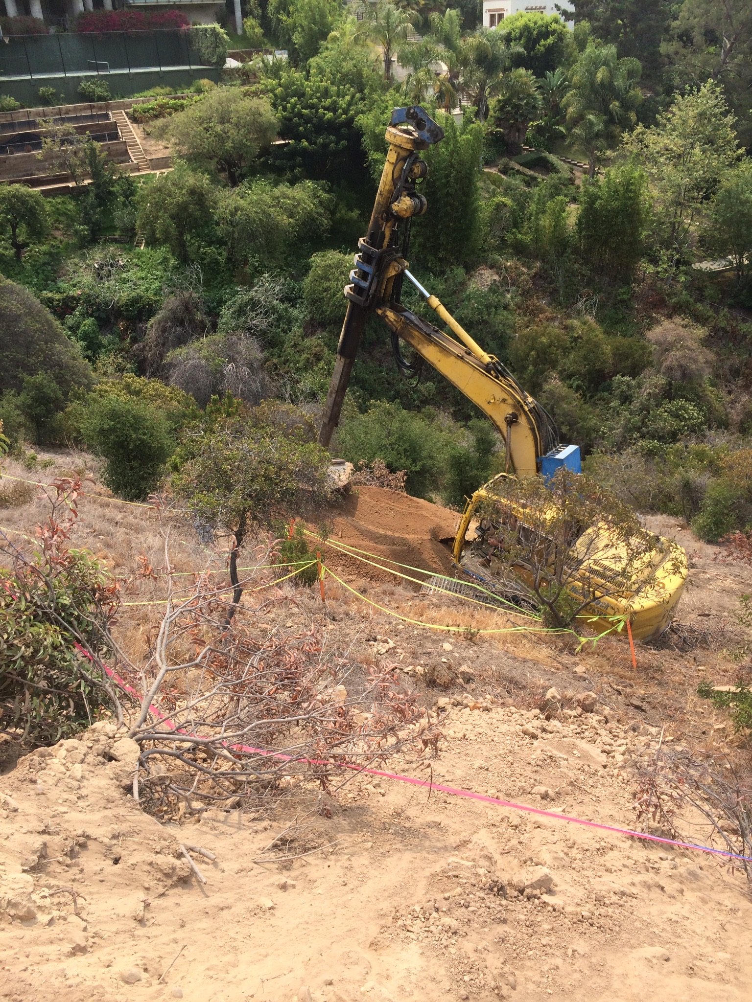 Drill rig on a hillside caisson job