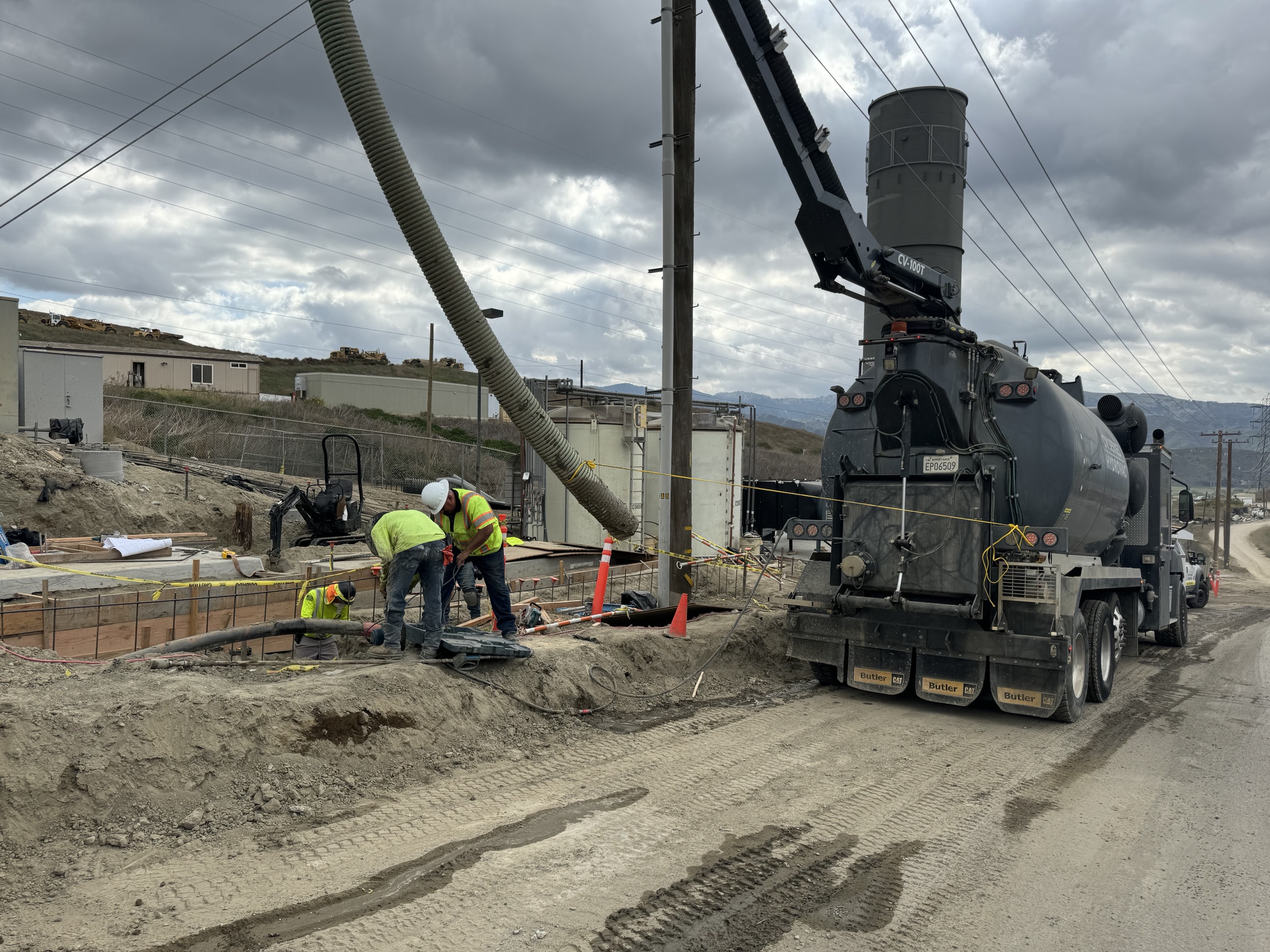 Hydrovac potholing beside the formed flare pad at a landfill