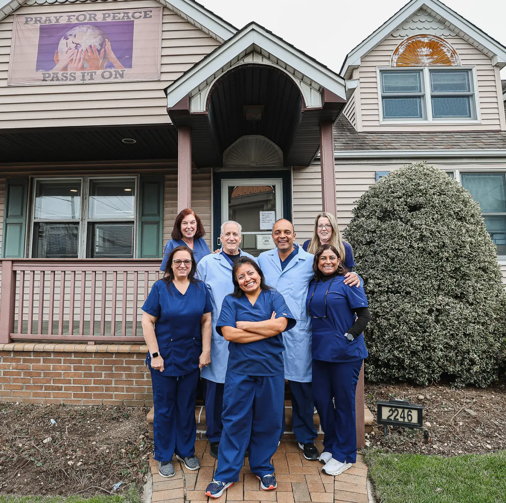 A group of doctors standing in front of a building.