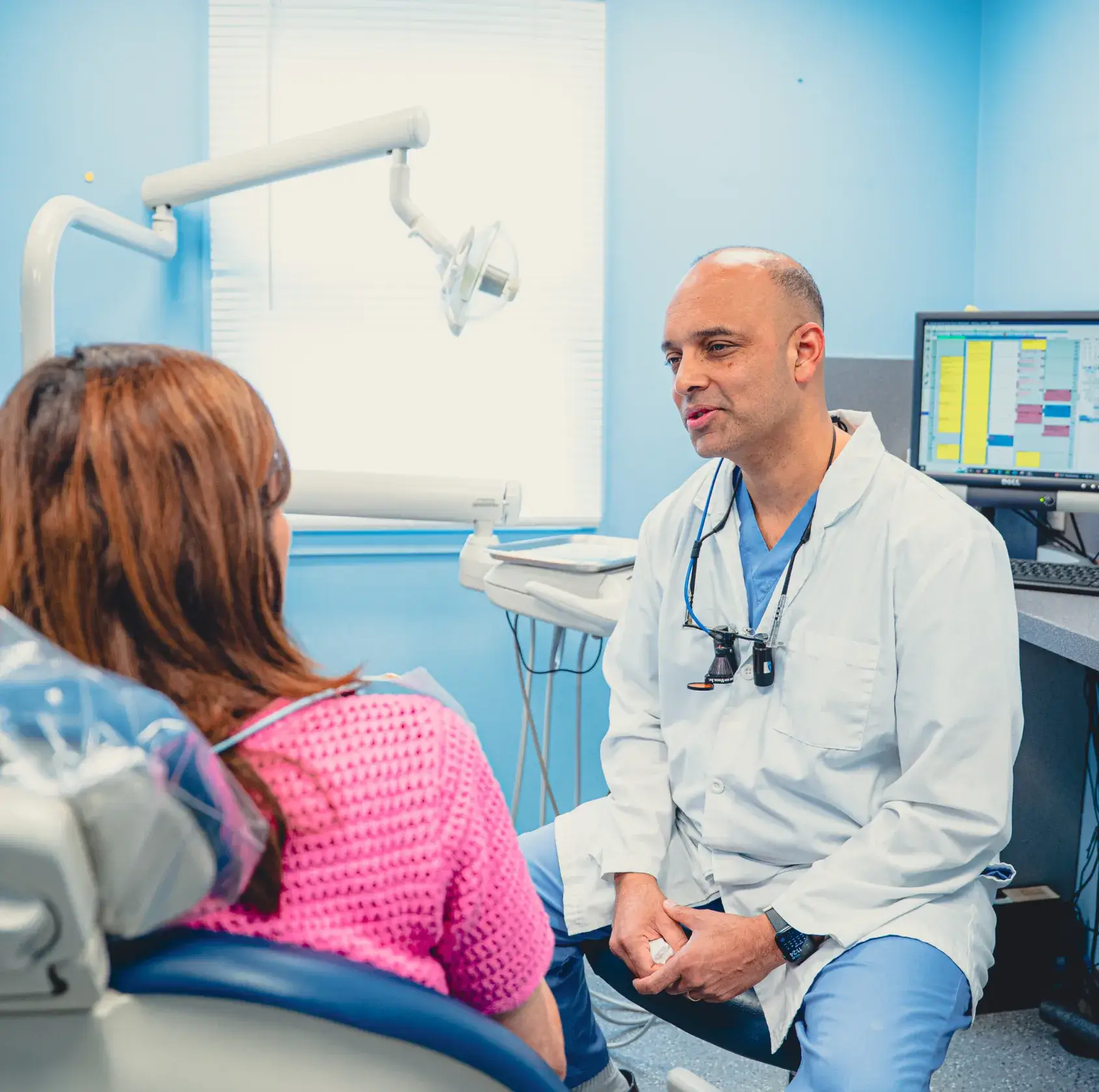 Dr. Cherian talking to patient