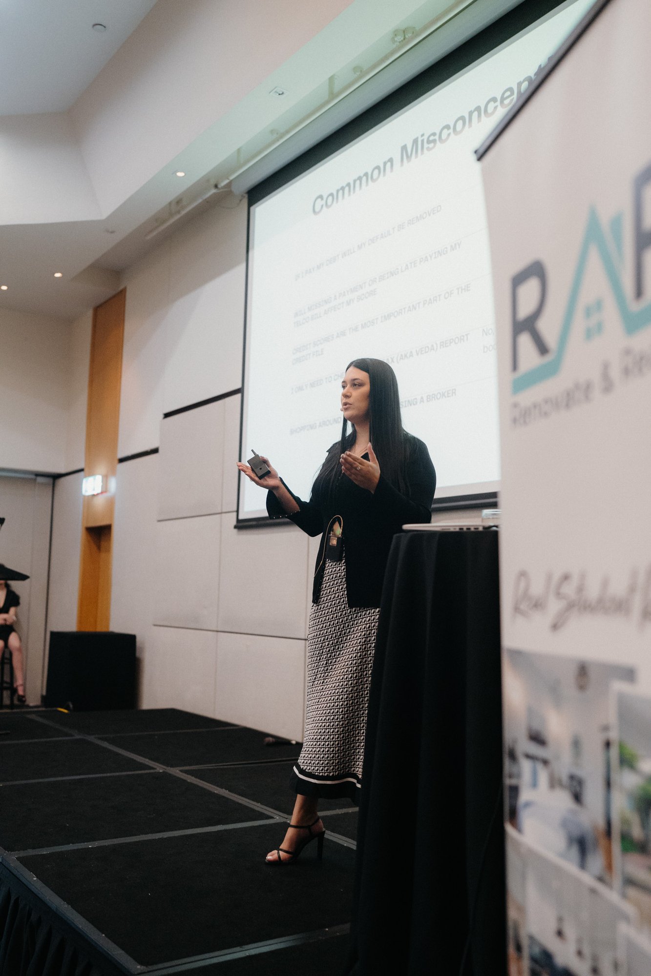 Larni Spilsbury-Vatselias speaking on stage