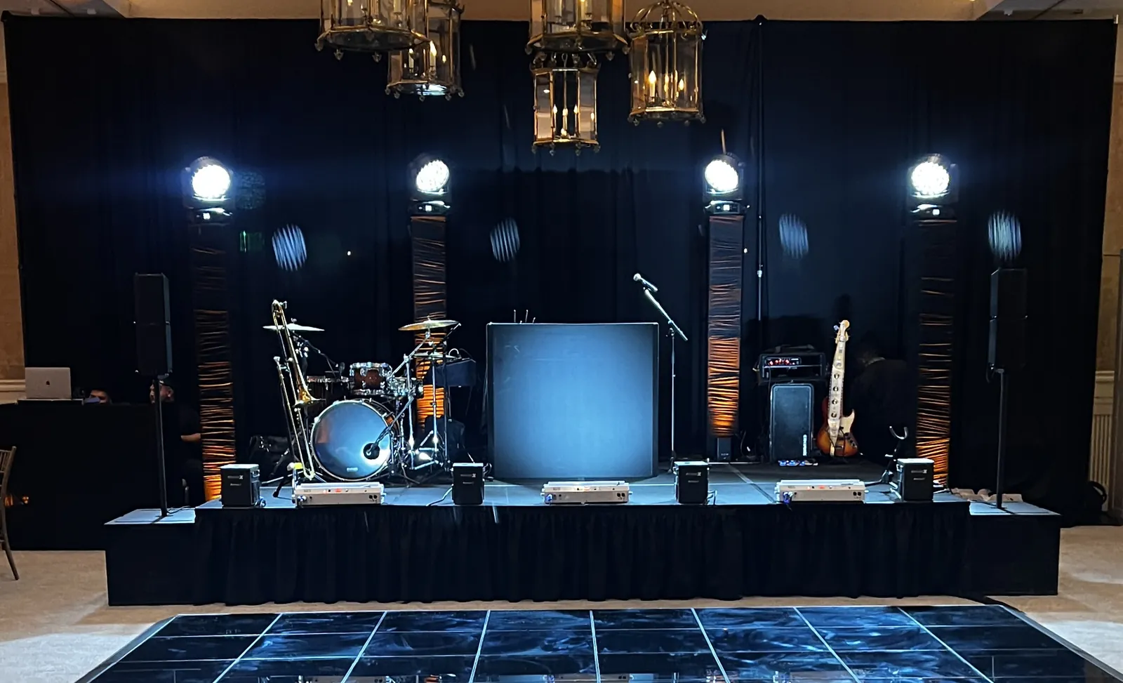 The DME AllStars on stage with full production lighting at a corporate event