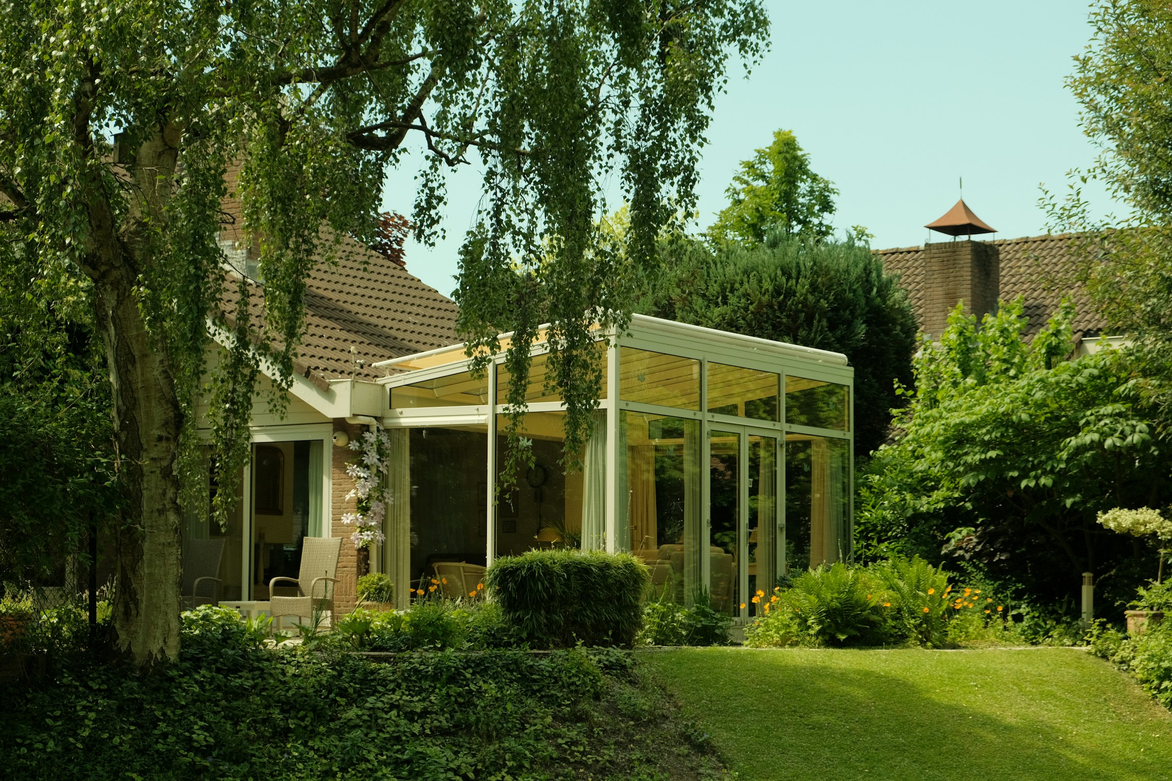 A bright sunroom addition with a wood ceiling