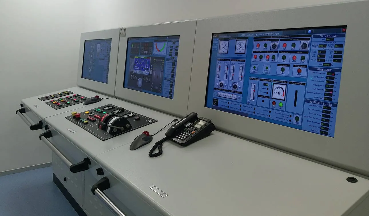 A grey engine control console with joysticks, a telephone and three screens of boiler and generator readings