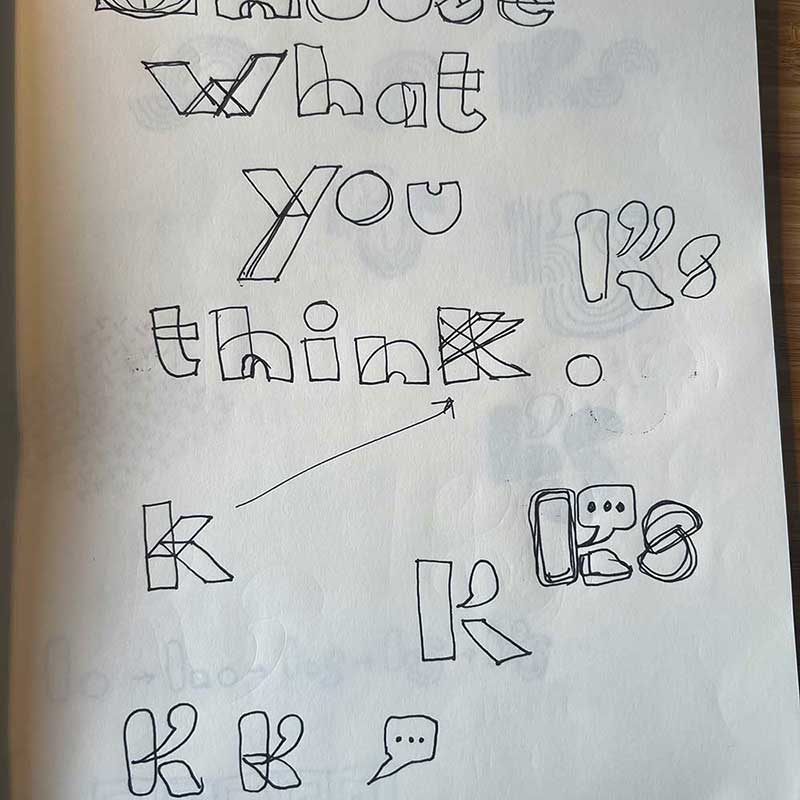 An exploration in tagline in a sketchbook, showing the words "choose what you think" in a creative hand-lettered font