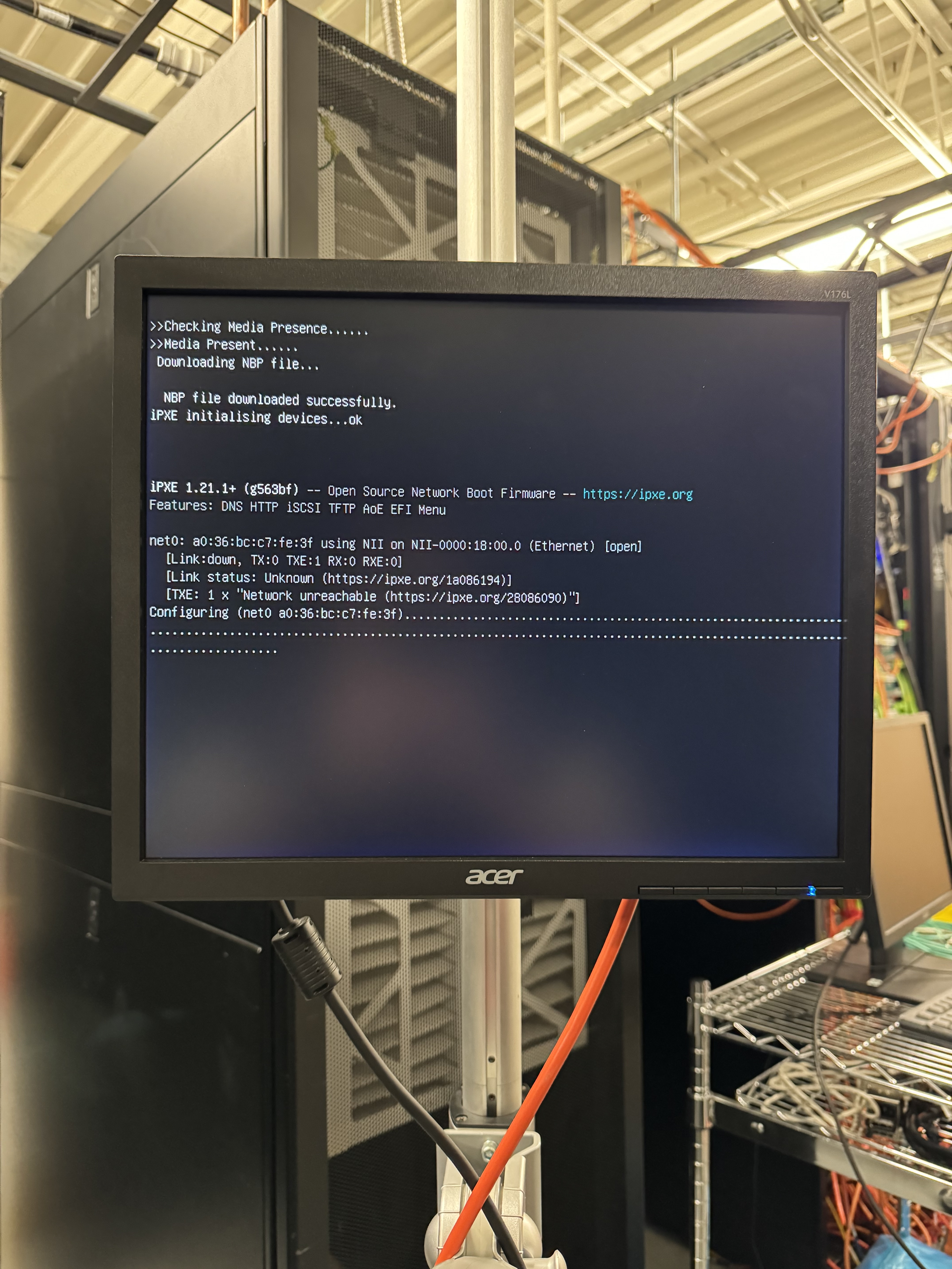 A monitor on a rack in the Advanced Clustering data center, showing a system booting during testing