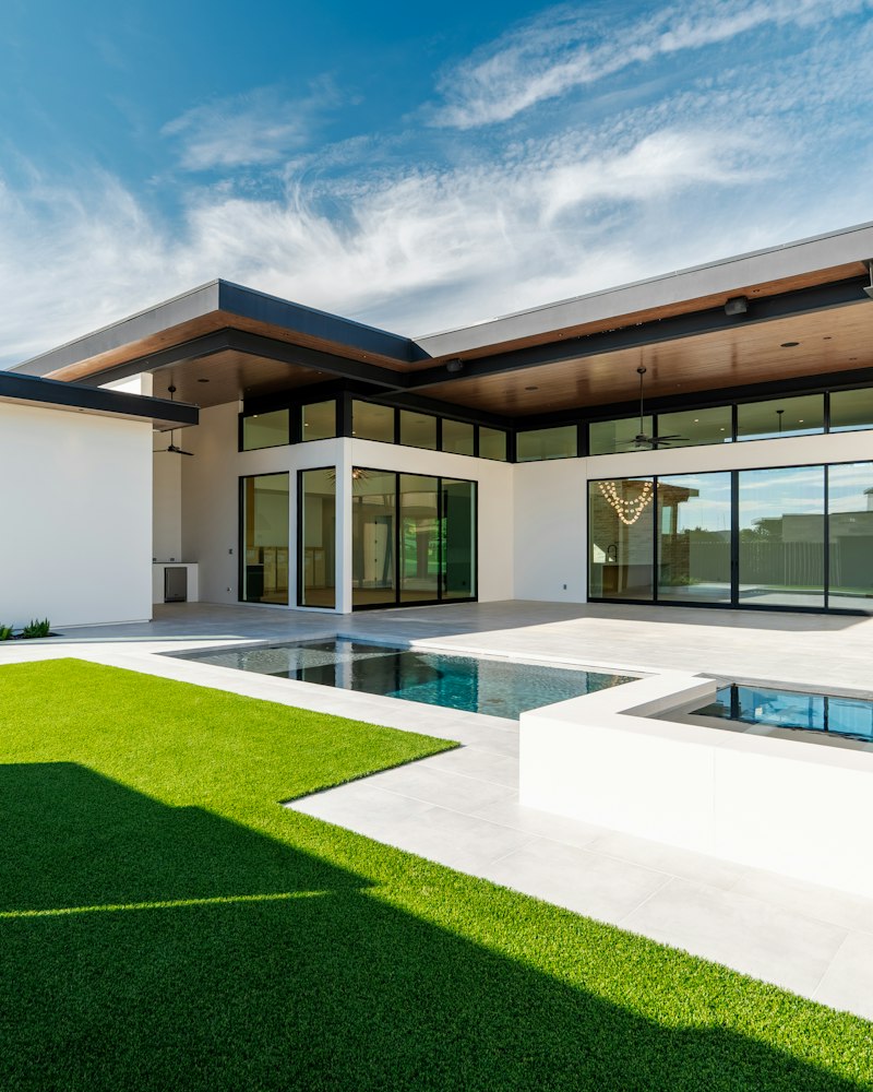 Modern backyard with a lawn and stone terrace
