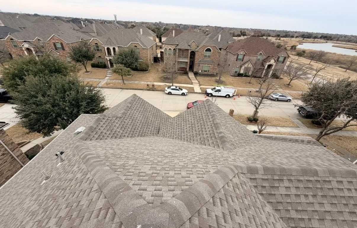 Aerial view of a new shingle roof overlooking a residential neighborhood