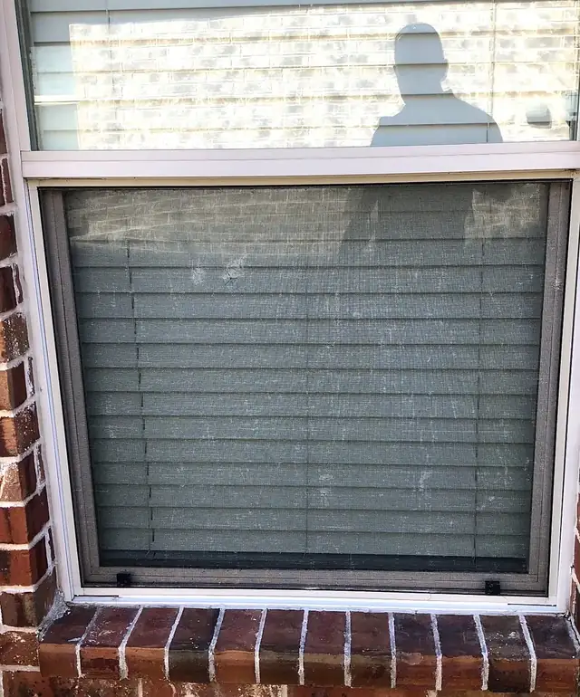 Window screen and frame checked for hail damage during inspection