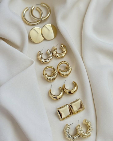 Rows of gold earrings ready for finishing