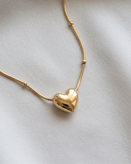 Necklace worn with a brown top