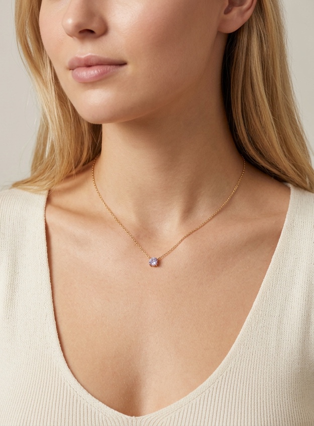 Gold station necklace on a model