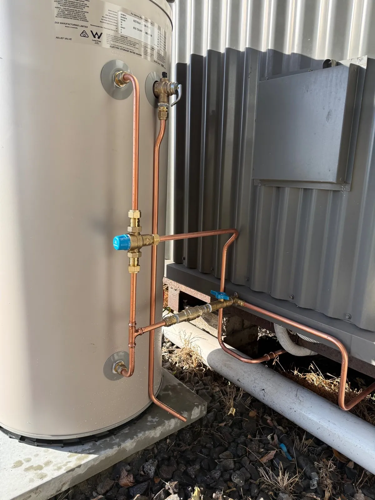 Electric storage hot water heater installed with neat copper pipework, tempering valve and isolation valve