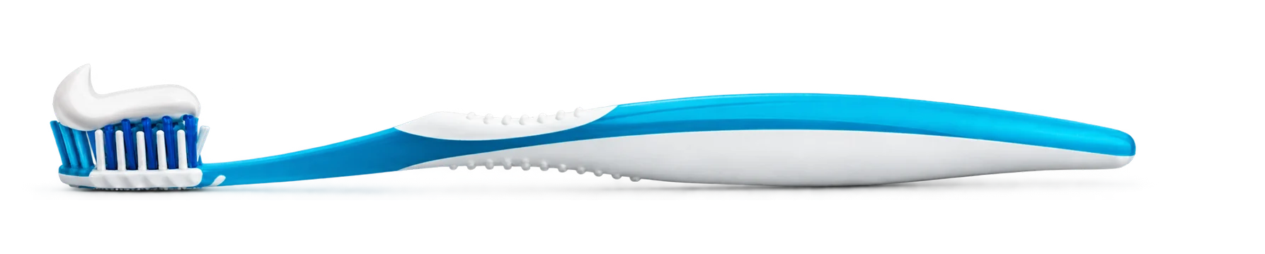 Toothpaste being squeezed onto a toothbrush
