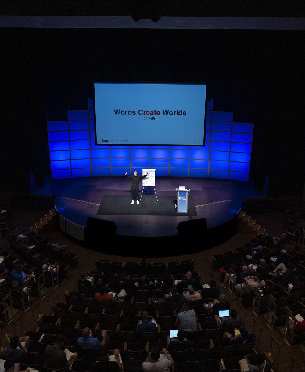 Ryan on stage in a full auditorium