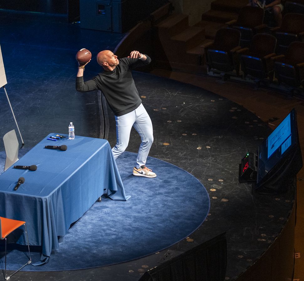 Ryan on stage throwing a football