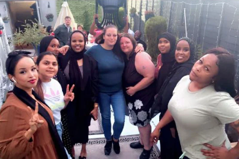 A group of the Oria Care team smiling together at an evening get-together