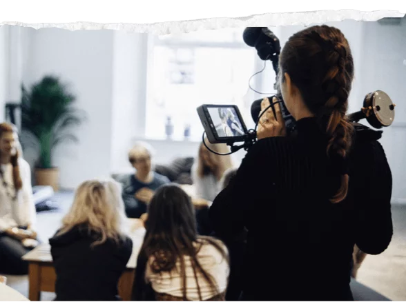 Videographer filming a group session