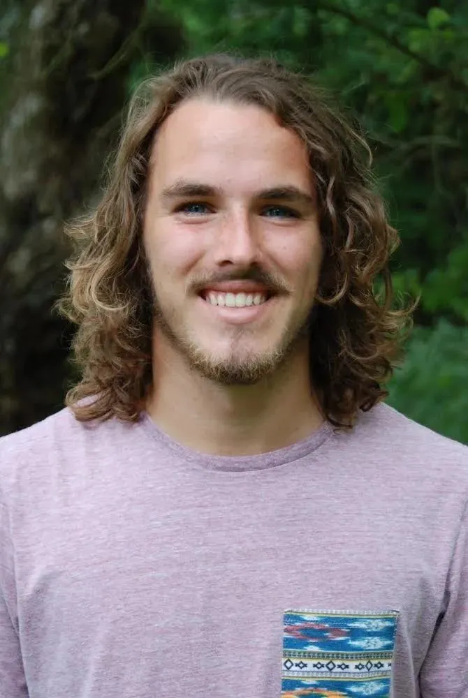 Portrait of JeanPaul Judice smiling outdoors