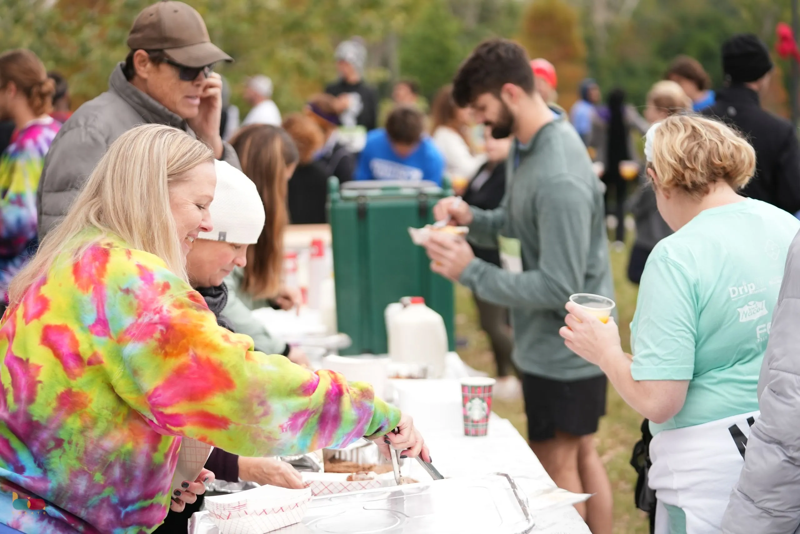 Volunteers serving drinks to trotters at the refreshment table