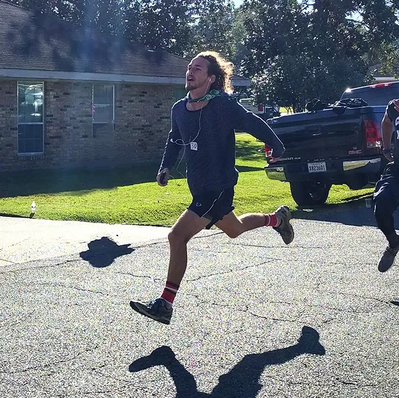 JeanPaul running down a neighborhood street during the trot