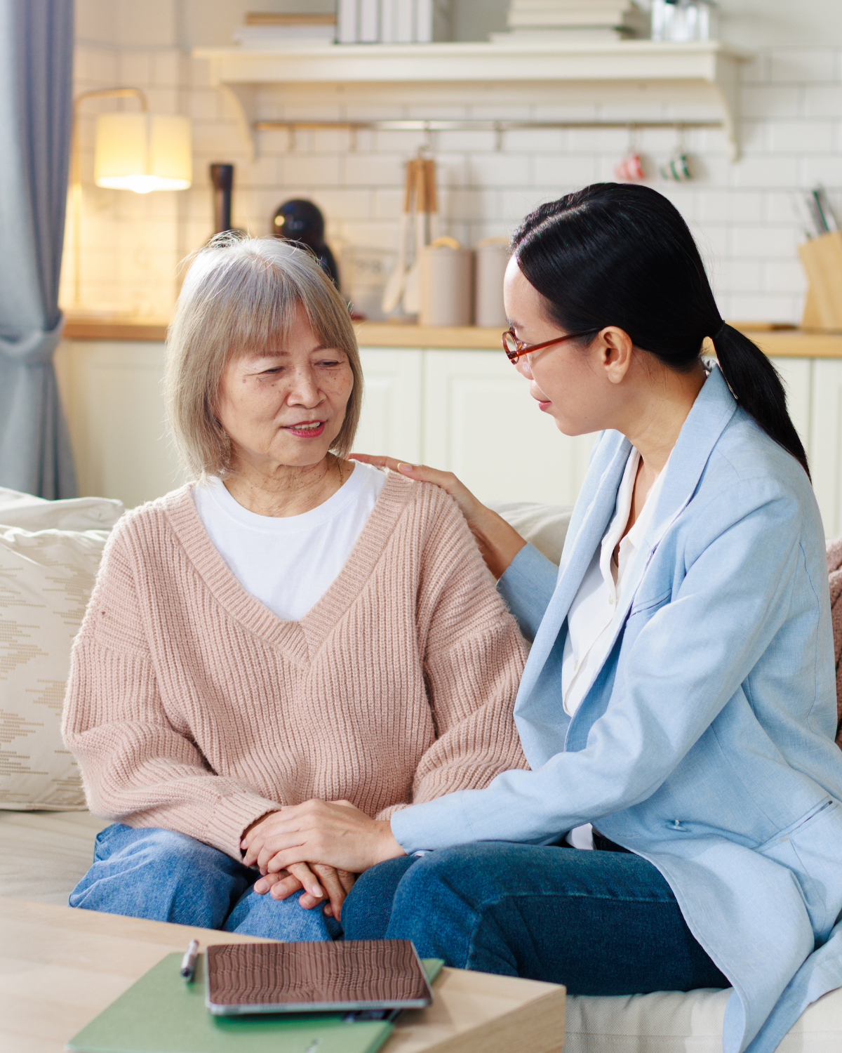 Caregiver speaking with an older adult in a comfortable home