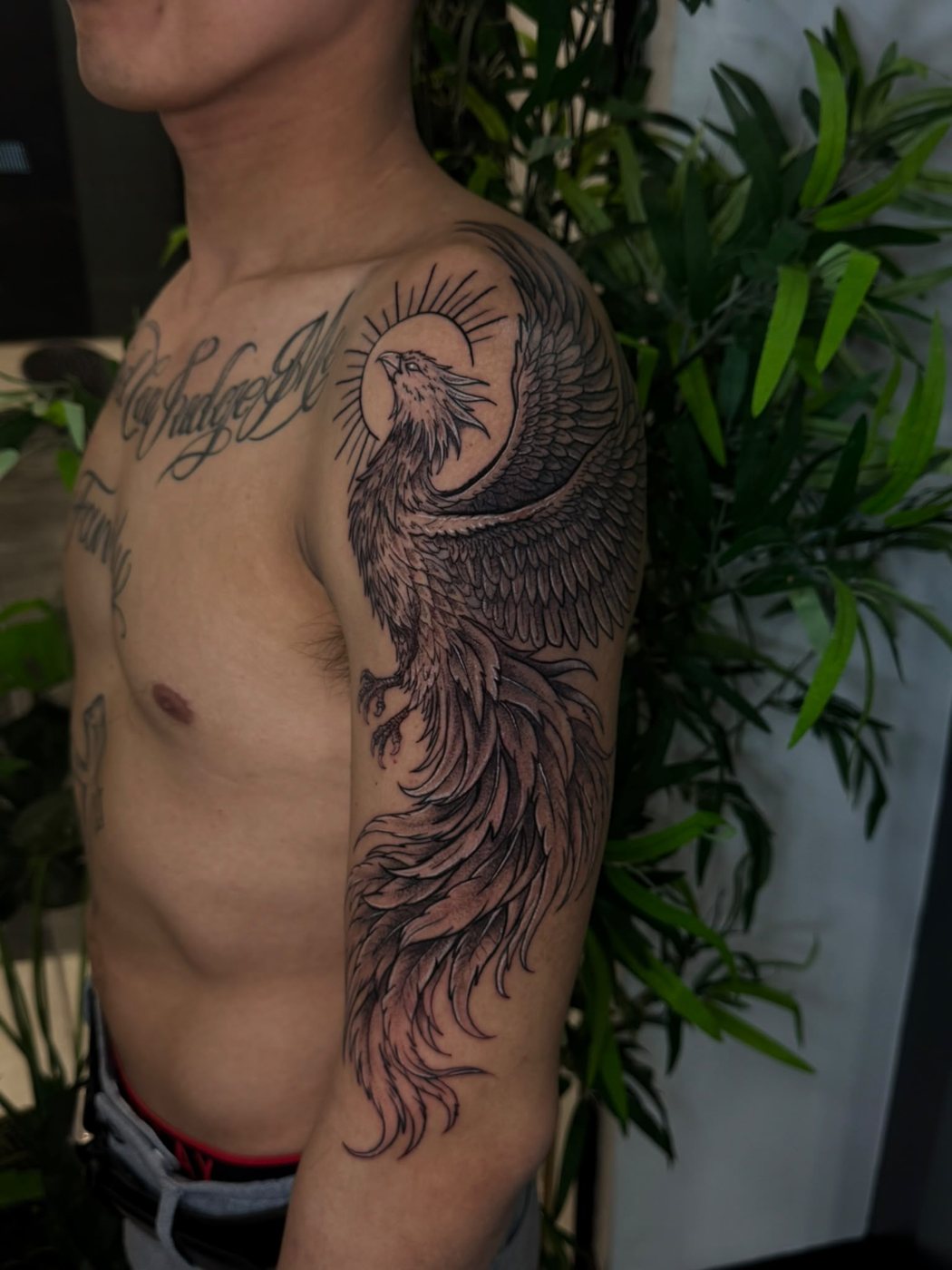 Black and grey phoenix shoulder and chest tattoo by Augusto at Squires Ink, Surfers Paradise