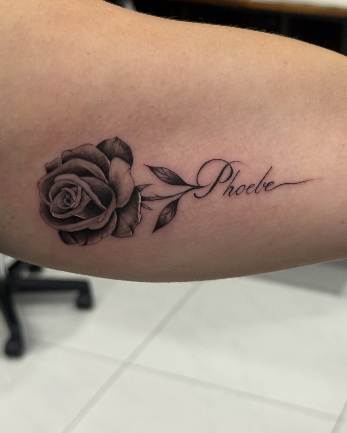 Fine line rose with script upper arm tattoo by Santiago at Squires Ink, Surfers Paradise