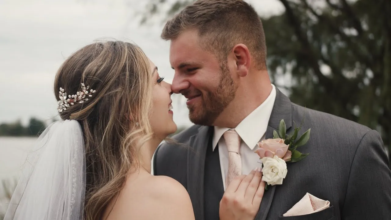 Jacquelyn and Brad, nose to nose and smiling, on their wedding day