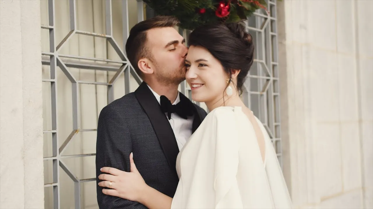 Mackenzie and Zach cheek to cheek in a winter doorway on their wedding day