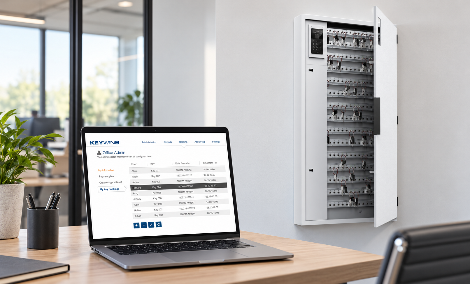 Wall-mounted KeyControl key cabinet with door open beside a laptop running KeyWin6
